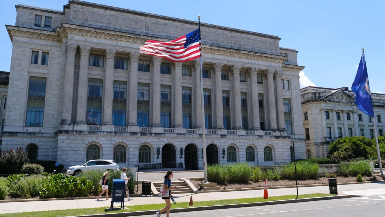 USDA headquarters in Washington, D.C., neoclassical building with tall columns, American and USDA flags flying.