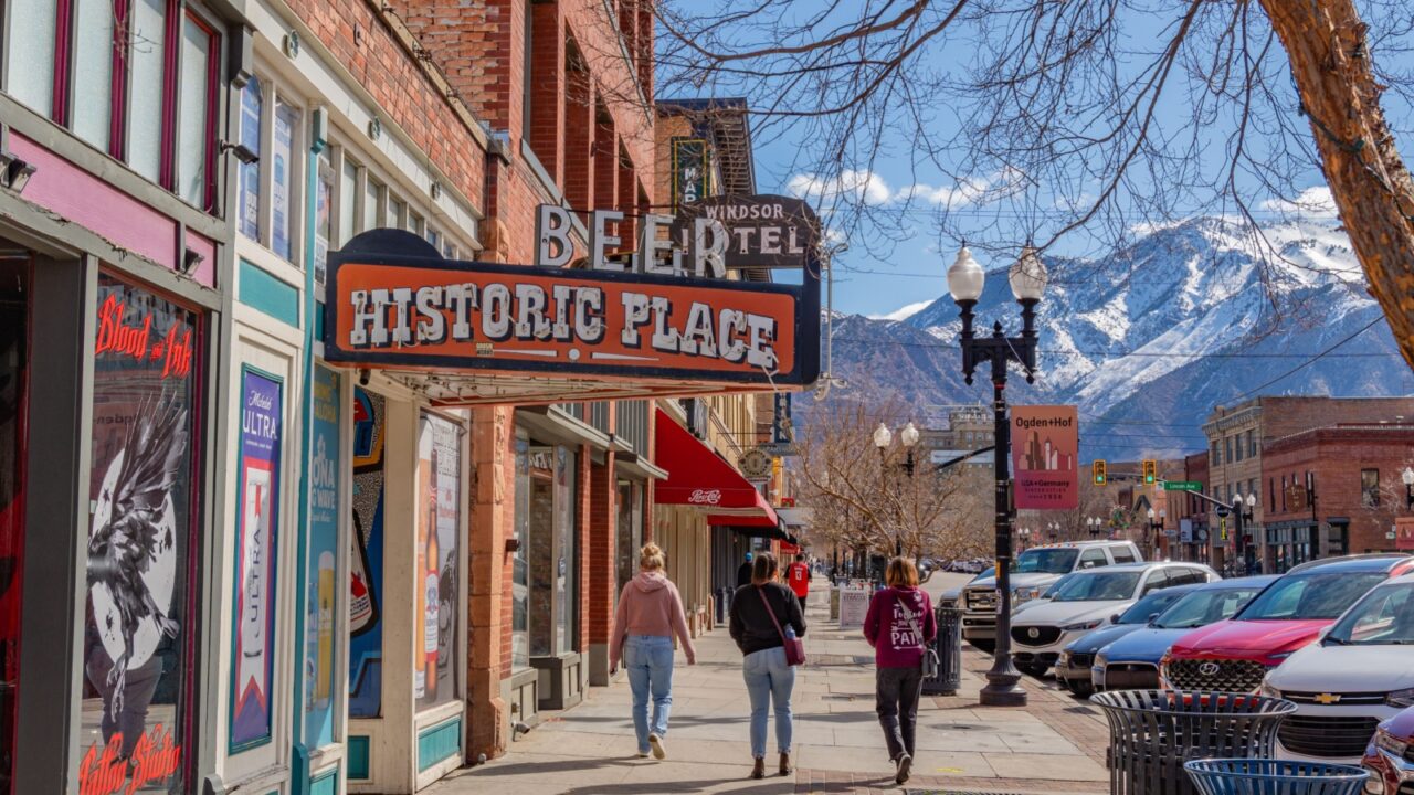 Ogden, UT, US-March 23, 2025: Historic downtown of this Utah city with quaint brick buildings and scenic snow-capped mountains in background.