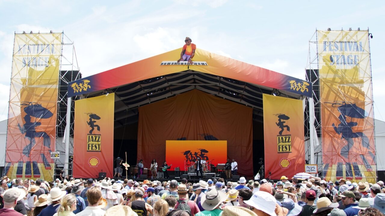 New Orleans, LA United States - April 30, 2022: Crowds at the 2022 New Orleans Jazz and Heritage Festival on the "Festival Stage" dance to funk legend Big Sam's Funky Nation.