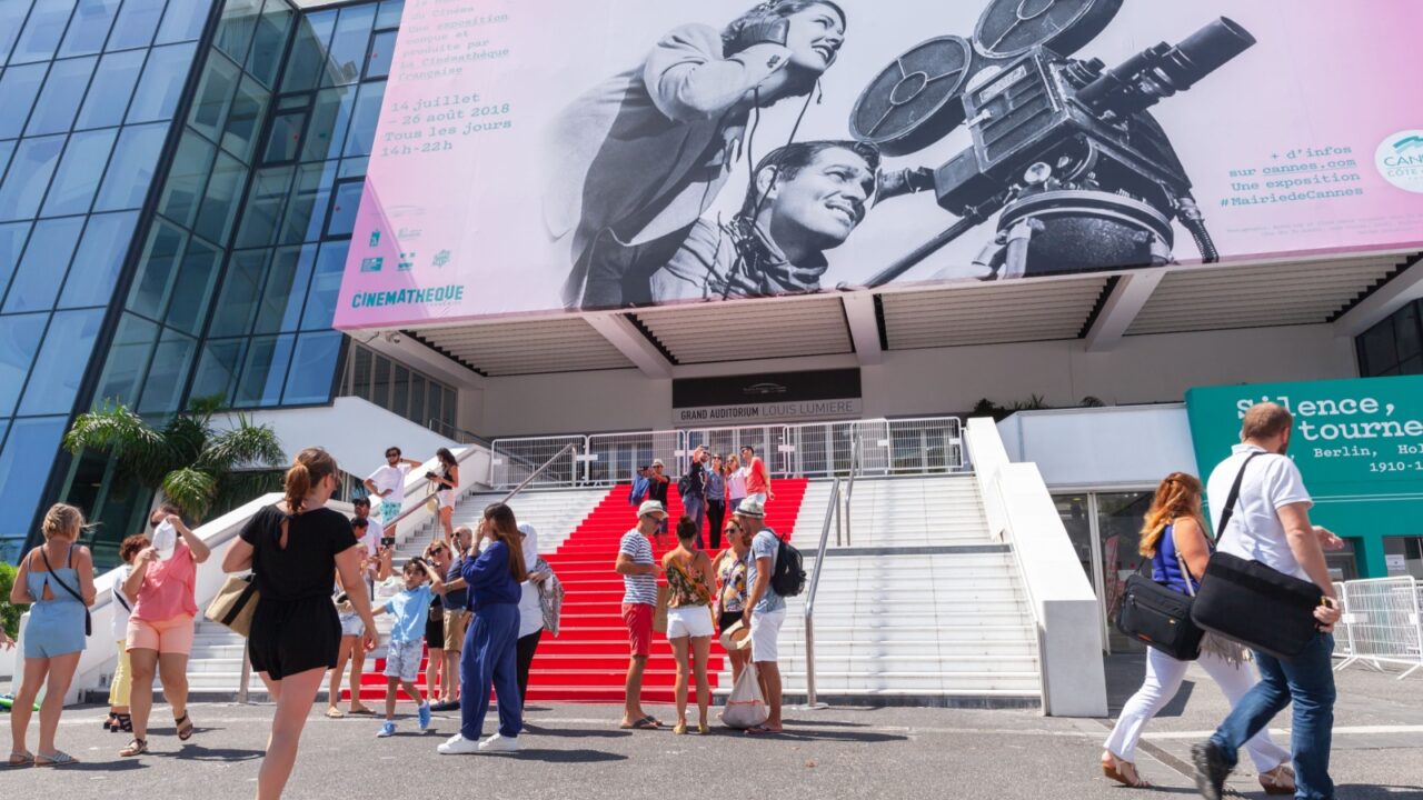 Cannes, France - August 14, 2018: Tourists are in front of Palais des Festivals et des Congres, a convention center, the venue for the Cannes Film Festival, the Cannes Lions International Festival