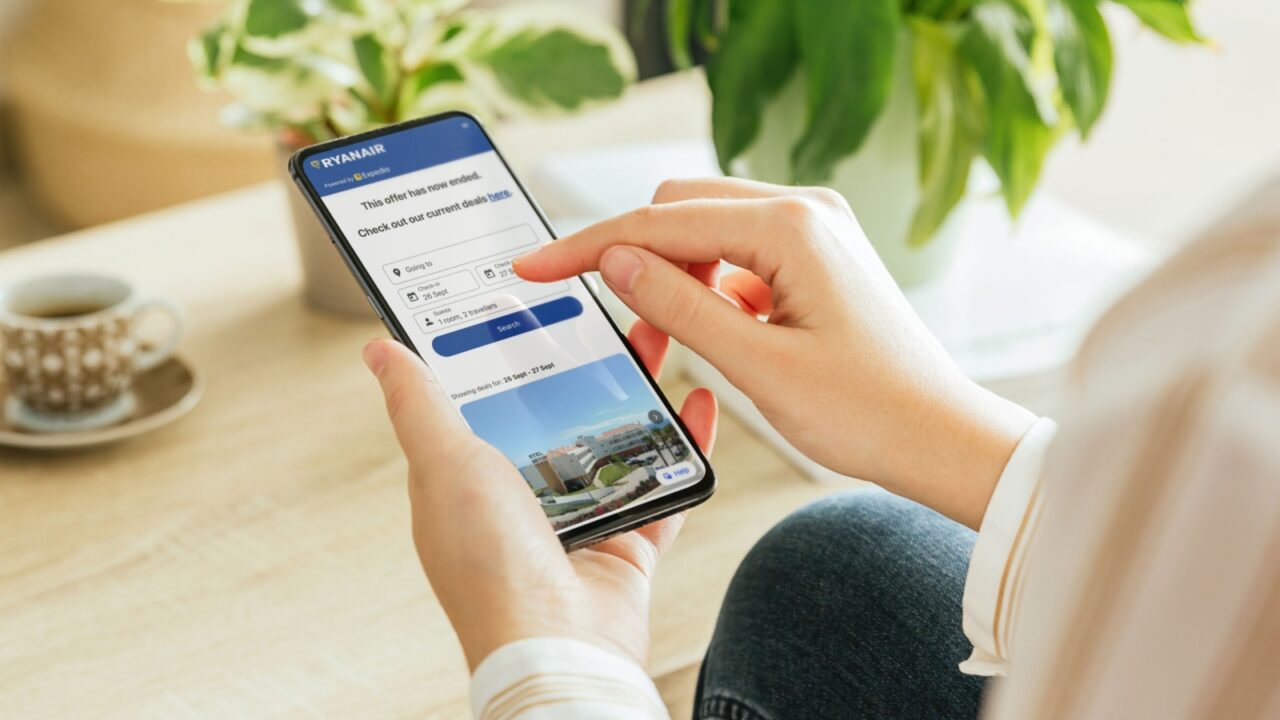 Madrid, Spain; 08 27 2025 Woman using ryanair mobile app on smartphone for booking flight tickets