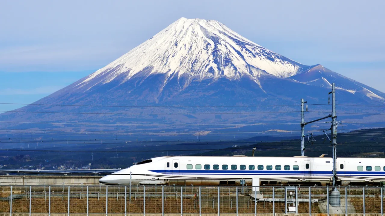 a bullet train passes below mt fuji in japan