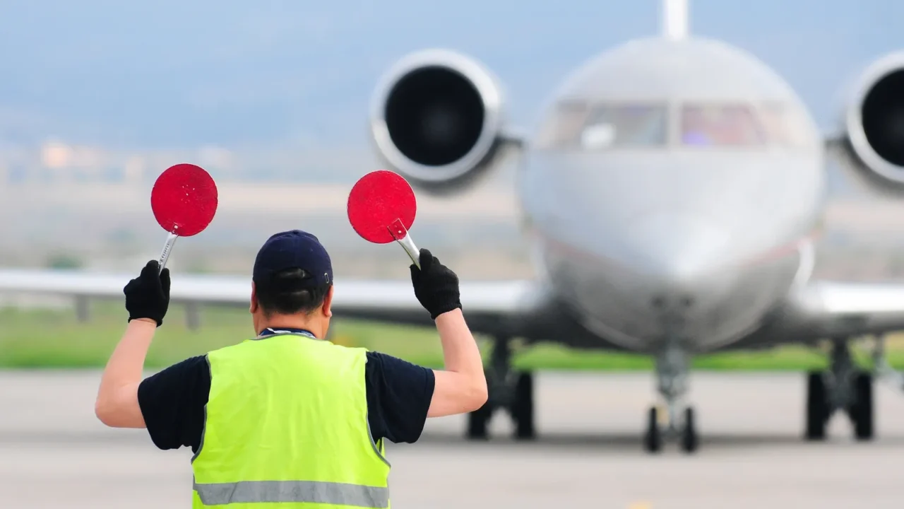 air traffic controller holding signs