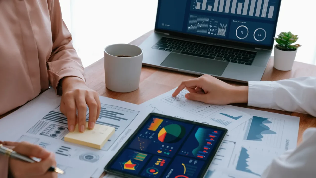 analyst team colleague discuss financial data on digital dashboard analyzing