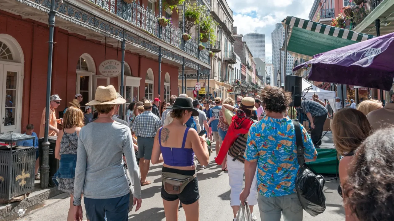 bourbon street in new orleans with people during the french