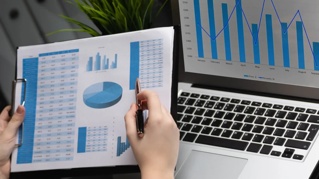 businessman analyzing investment charts with laptop accounting