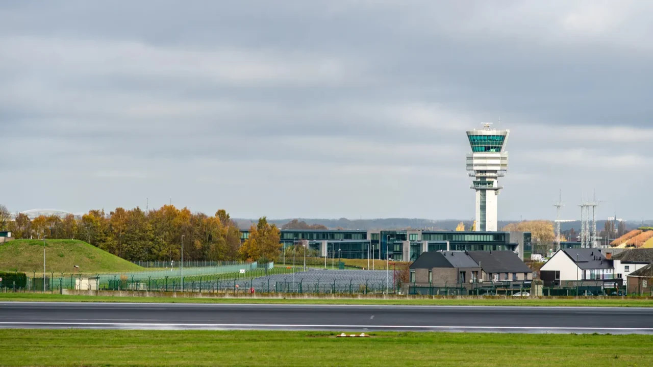 control tower at brussels airport zaventem rising above runways and