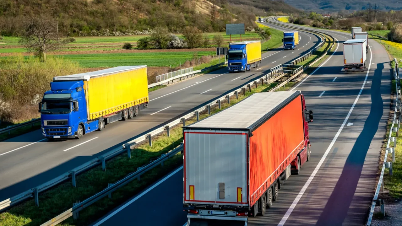convoys of transportation trucks in lines passing each other on