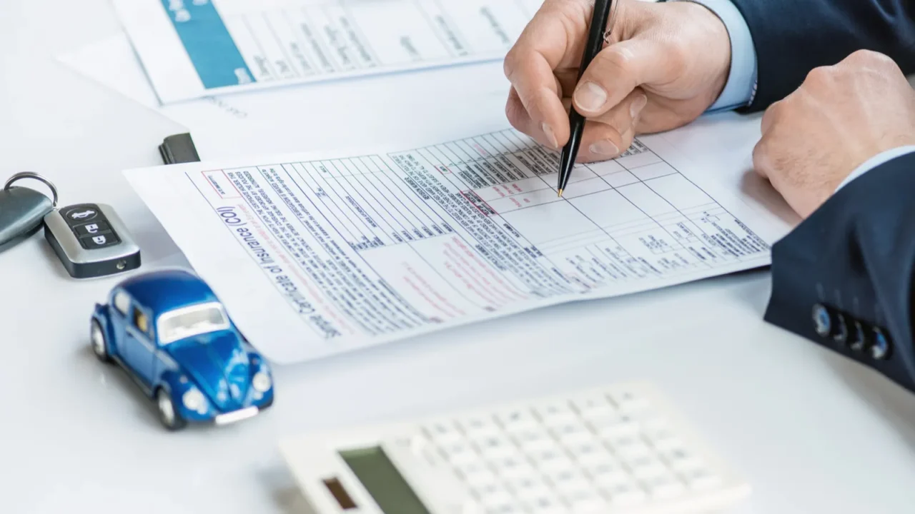 cropped view of man in formal wear signing insurance certificate