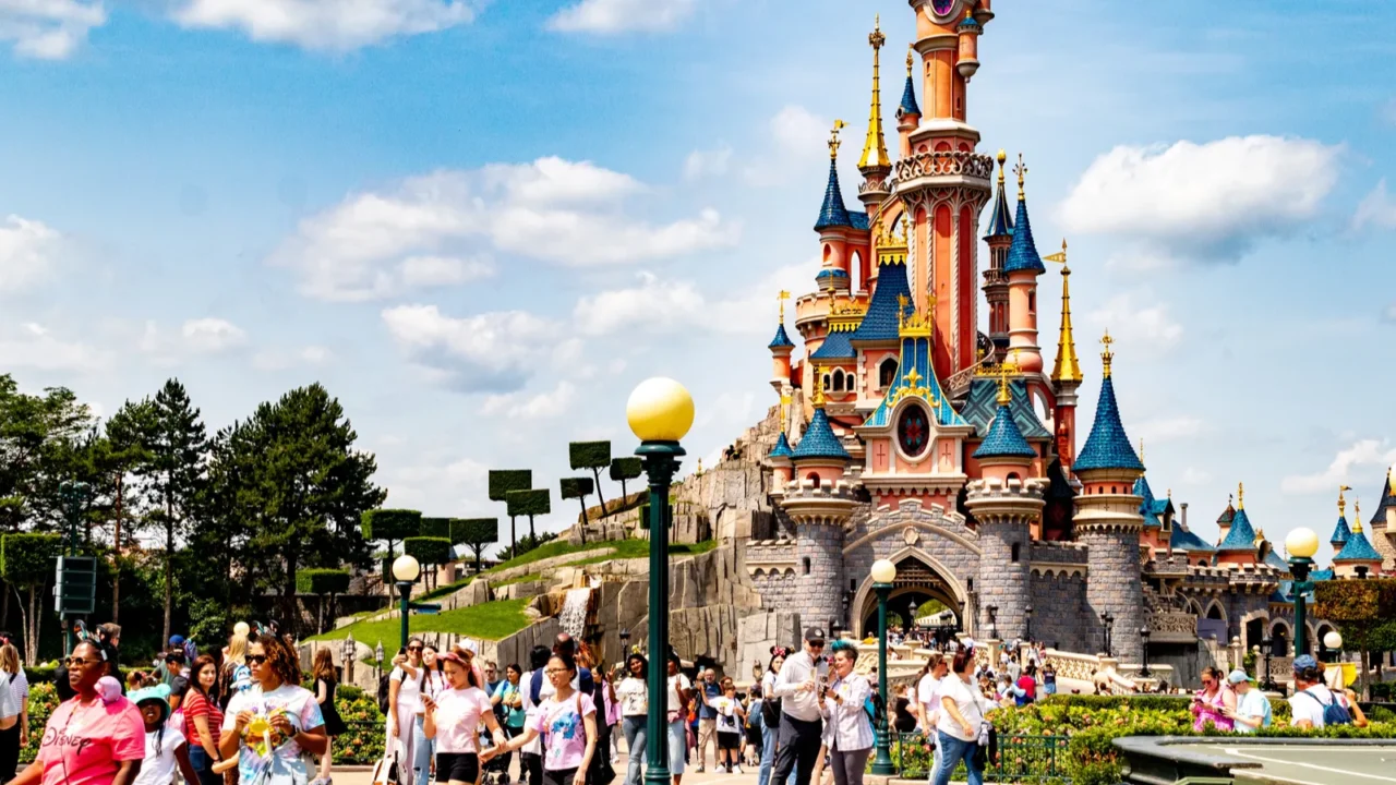 crowd of people in front of a fairytale castle under