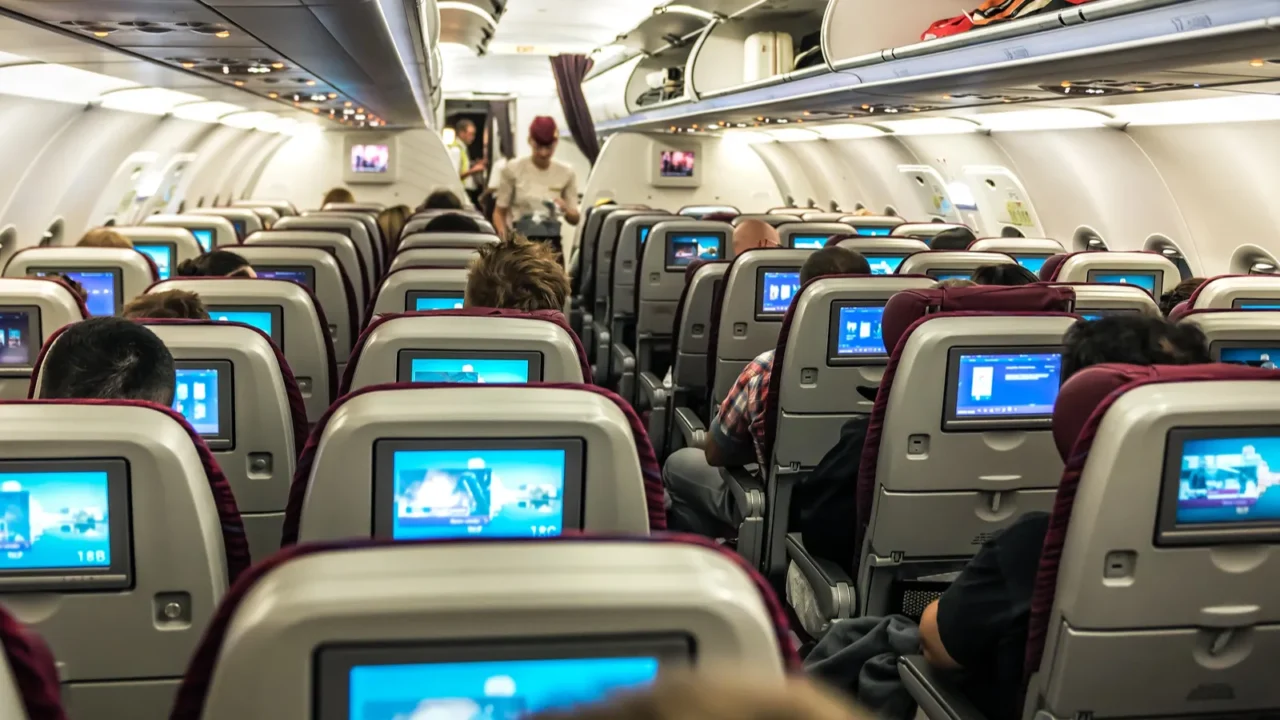full cabin of a passenger plane chairs with screen