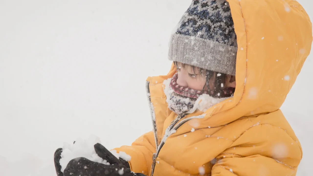 happy asian child playing in snow