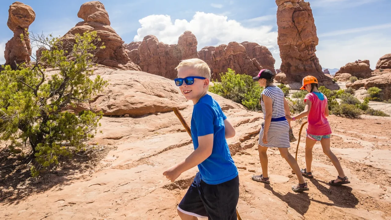 happy family hiking together in the beautiful rock formations of