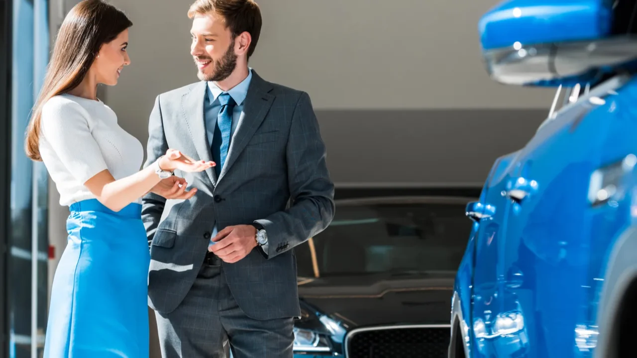 happy woman gesturing while standing and looking at handsome bearded