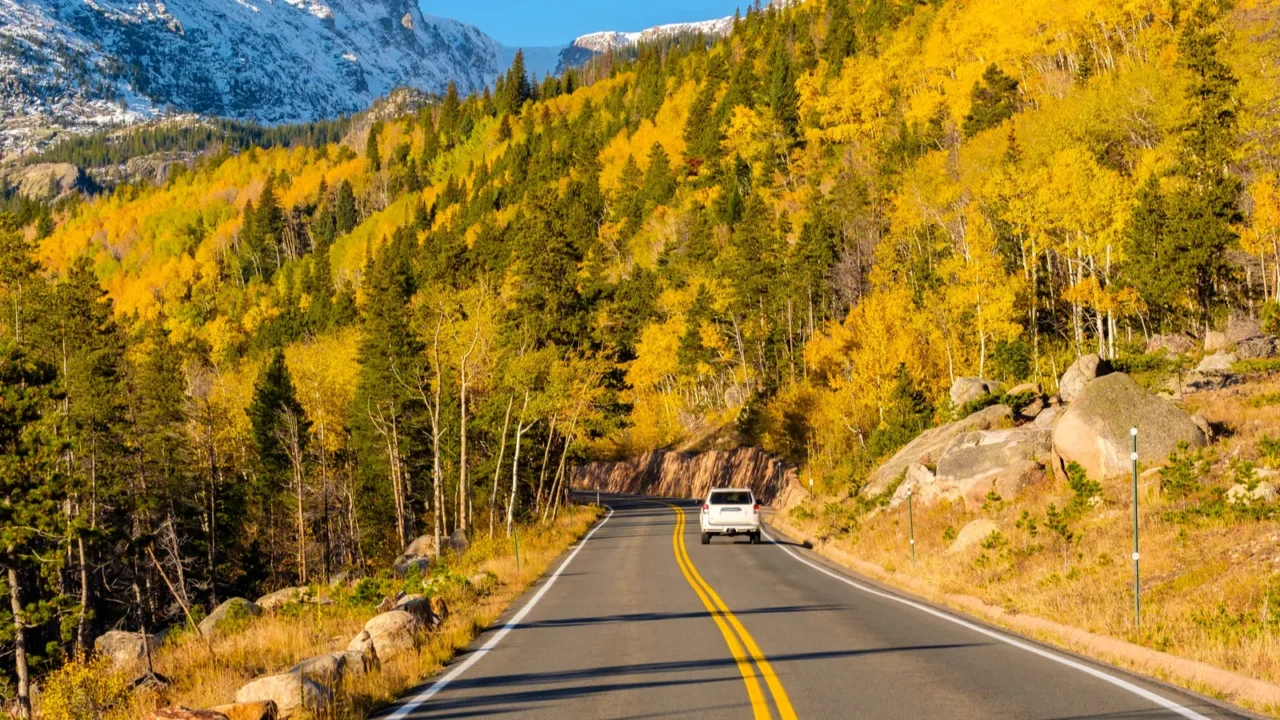 highway at autumn sunny day in rocky mountain national park