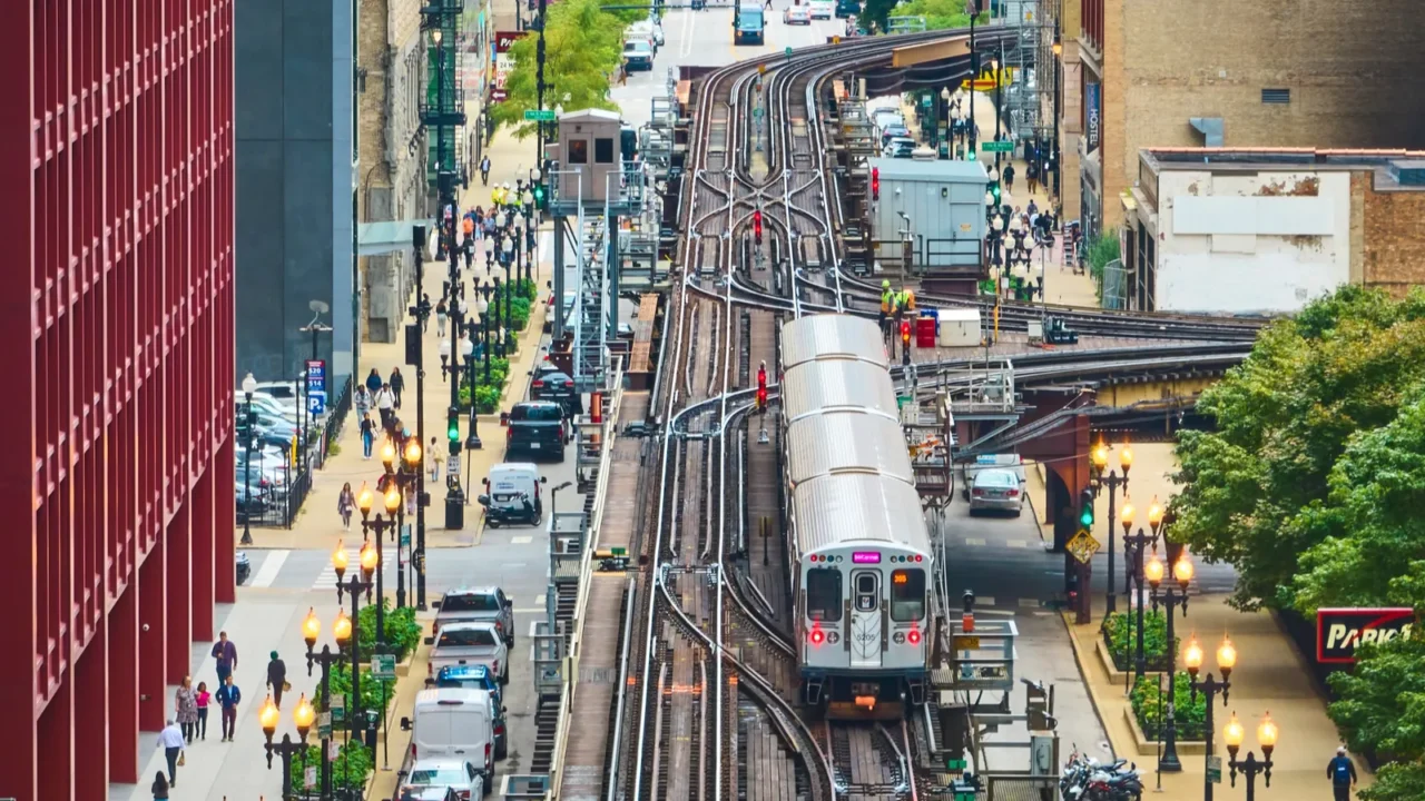 image of train on railroad in big inner city aerial