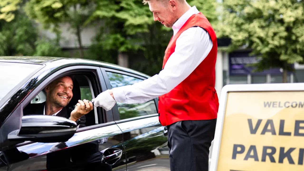 luxury valet service a man giving his car keys to