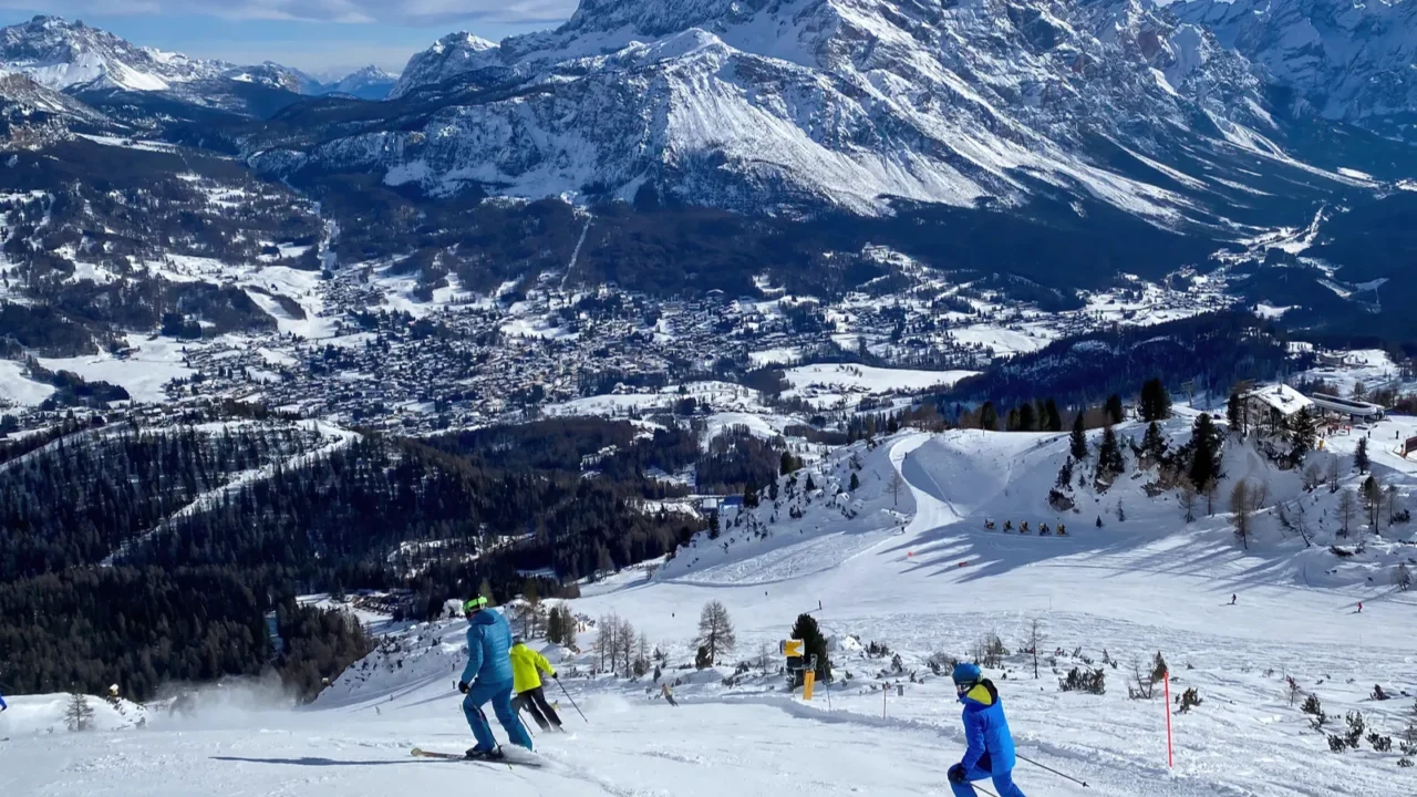 people skiing with panoramic view of ampezzo valley and monte