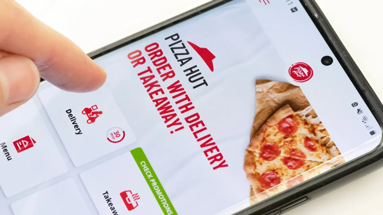 person ordering pizza hut food delivery on a smartphone mobile