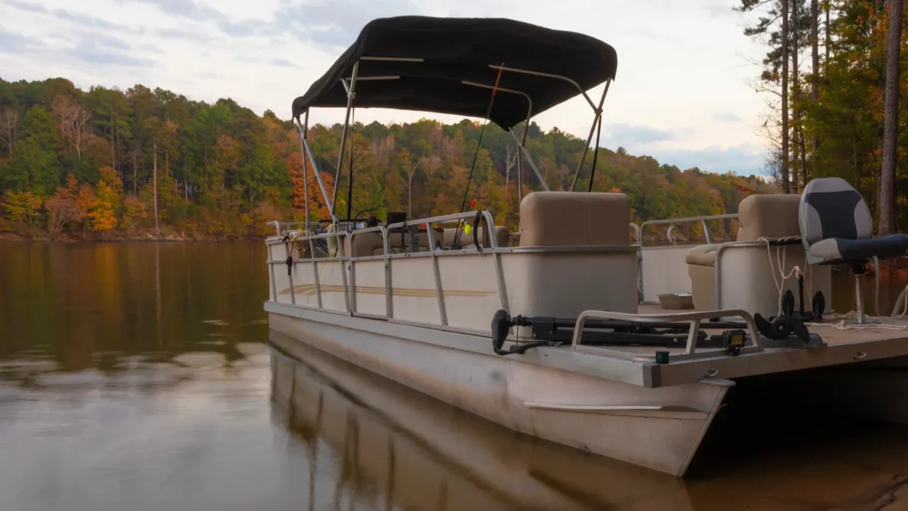 pontoon boat beached on the shore of falls lake in