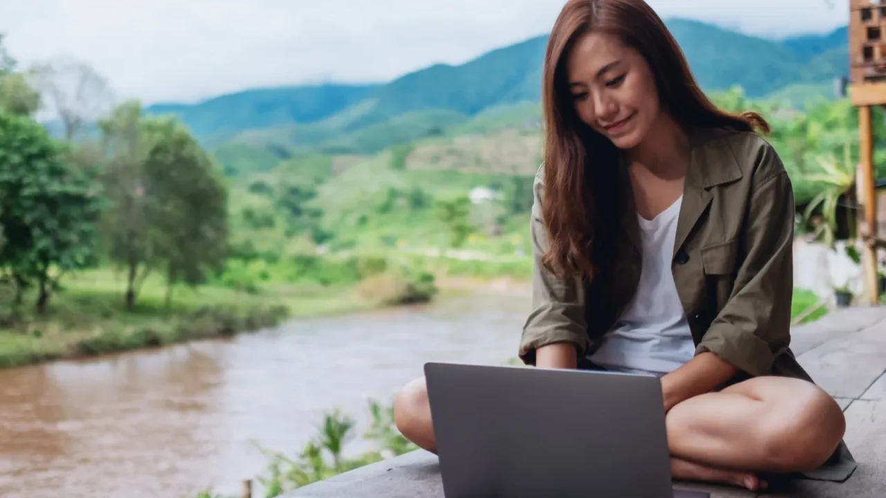 portrait image of a beautiful asian woman working on laptop