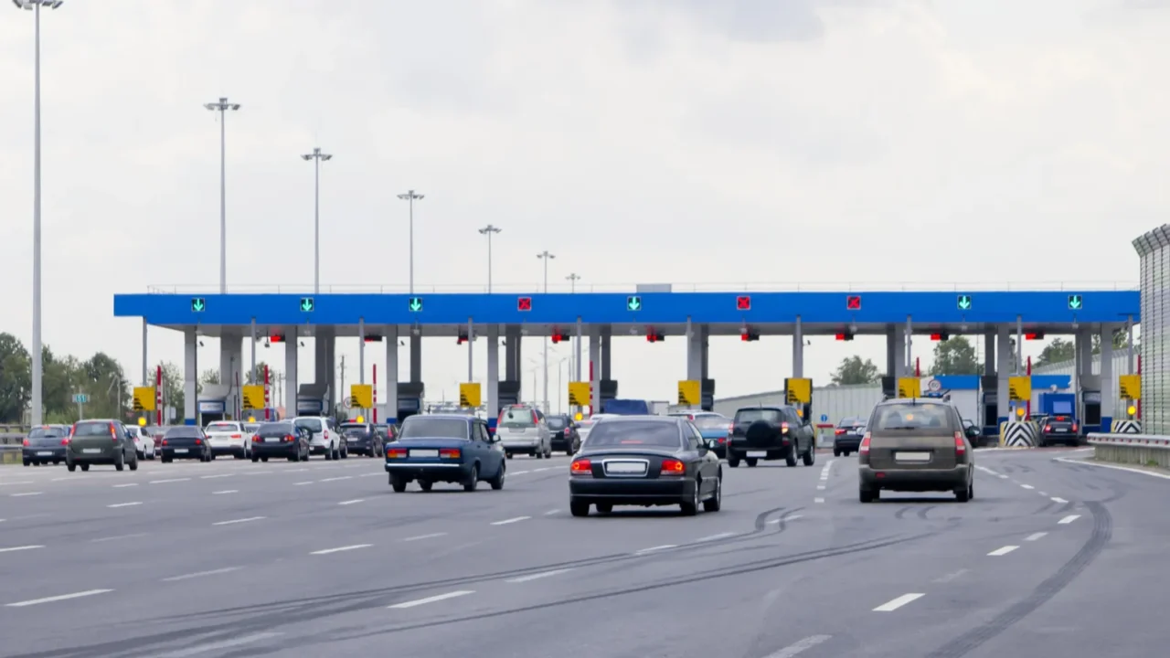 road tollgate with barriers by toll road on the highway