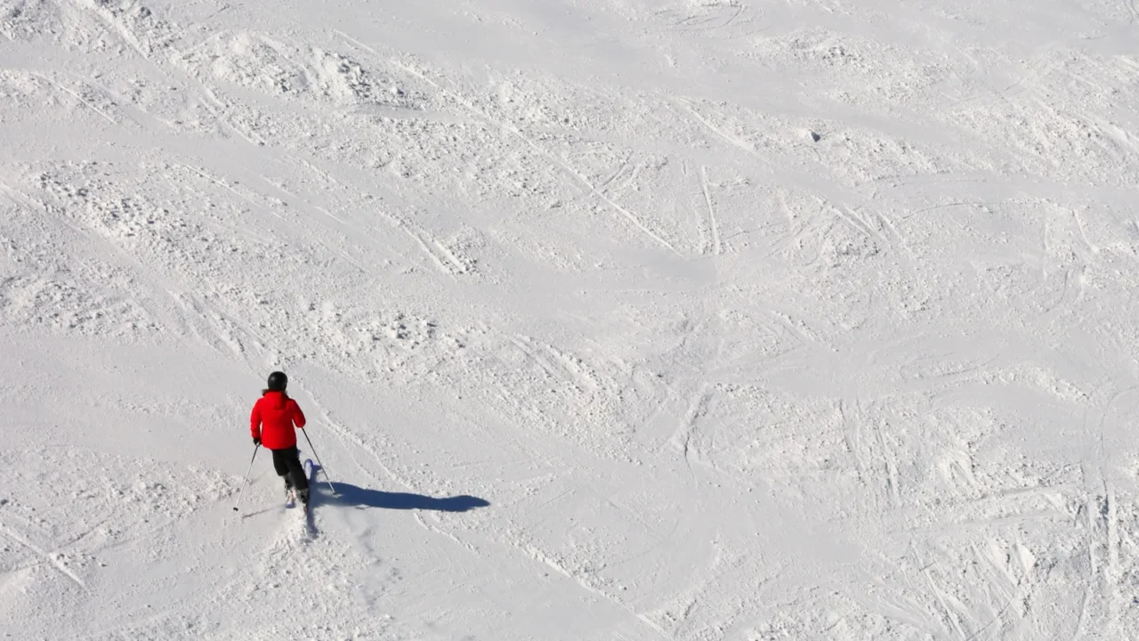 skier in the slope in the white snow in mountain