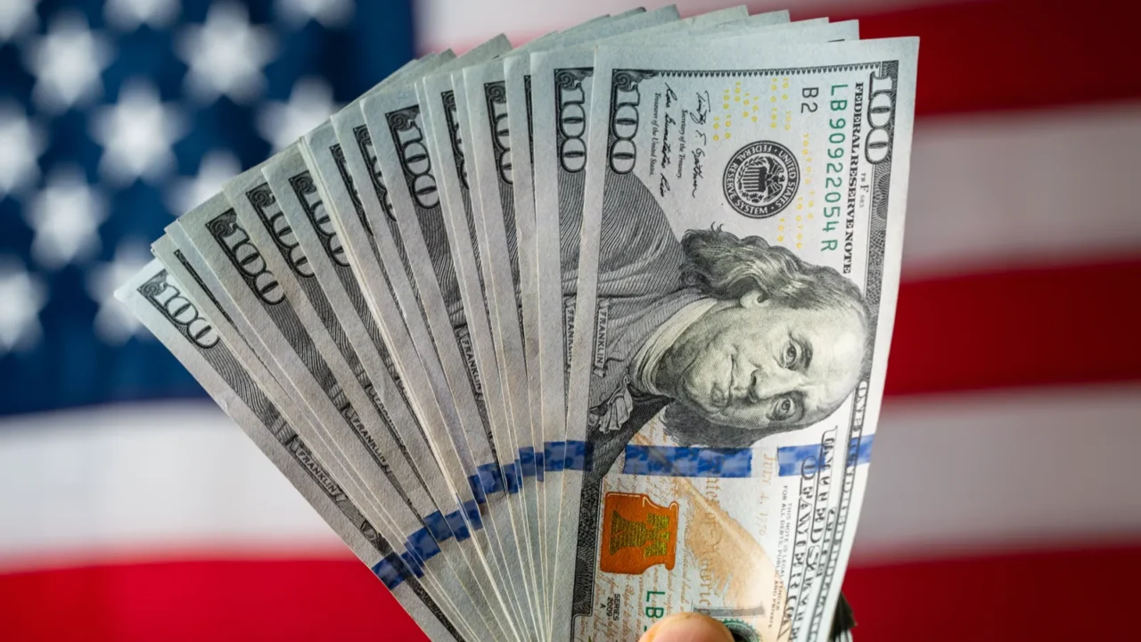 stack of american hundred dollar bills in a hand against