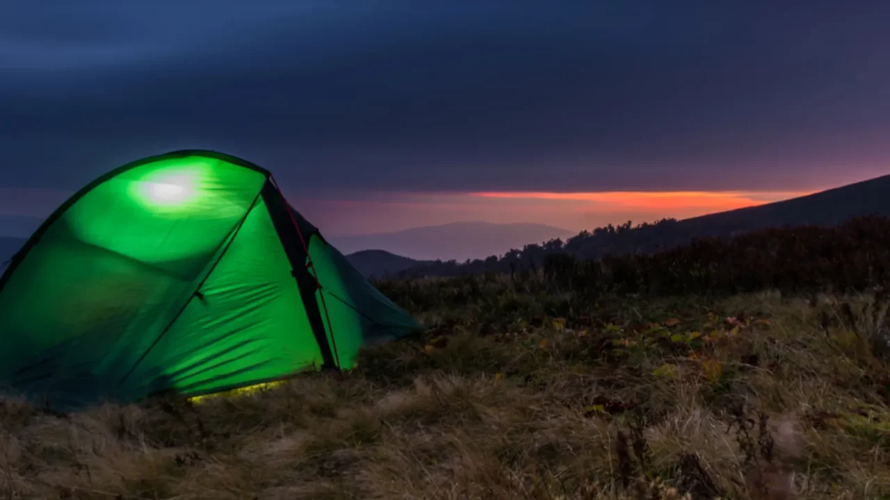 sunset in the mountains tourist tent in the foreground a