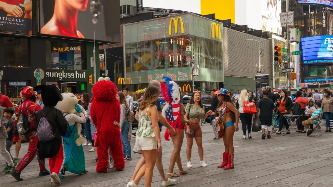 times square traffic buildings tourists city life