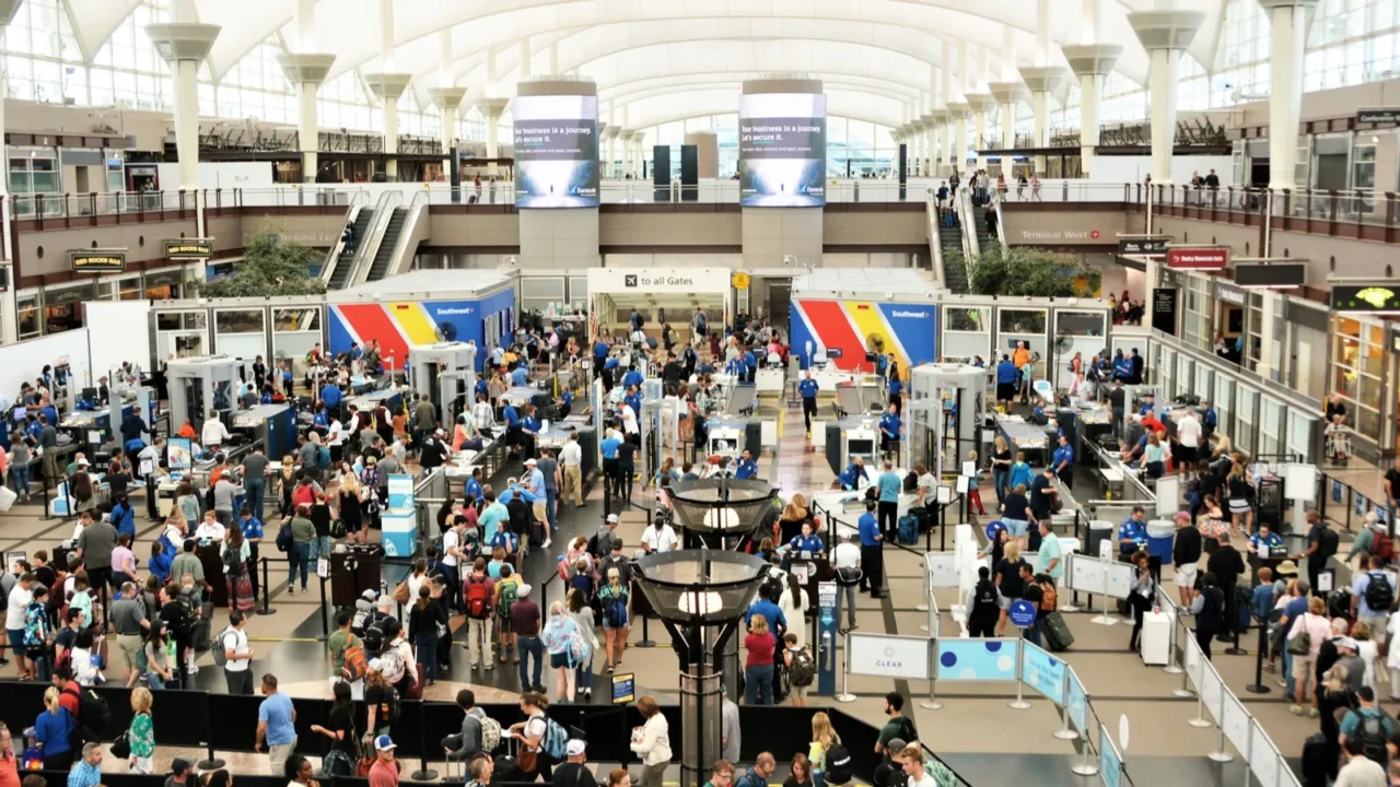 travelers at denver international airport going thru the security check