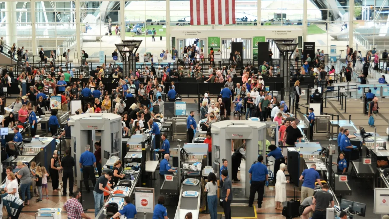travelers at denver international airport going thru the security check