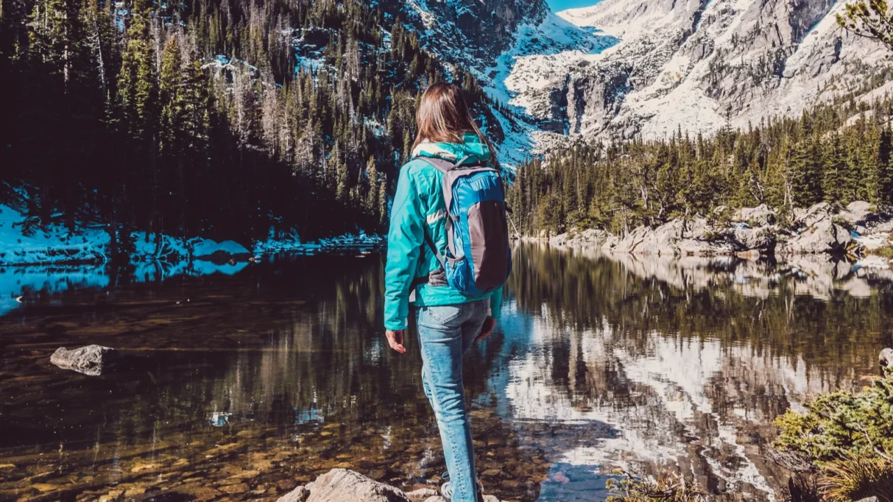 woman tourist near dream lake at autumn in rocky mountain