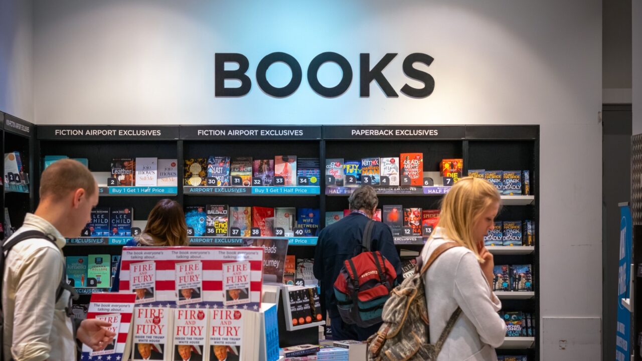 London, UK - August 12, 2018 - Travellers browsing in a bookshop at London Heathrow Airport terminal 5