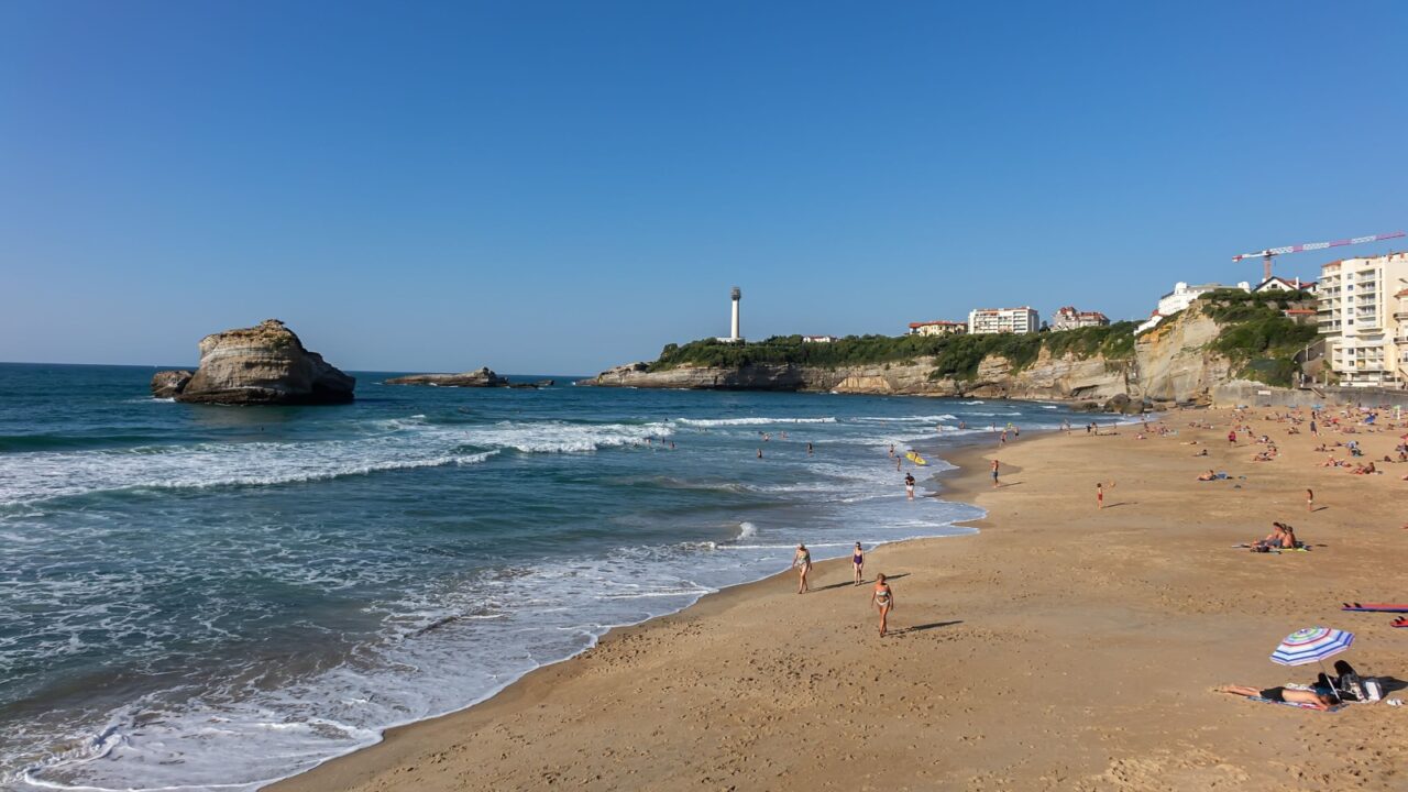 BIARRITZ, FRANCE - September 9, 2020: View of Miramar Plage an extension of Grande Plage, overlooking white lighthouse Phare de Biarritz. Atlantic coast, Basque country.