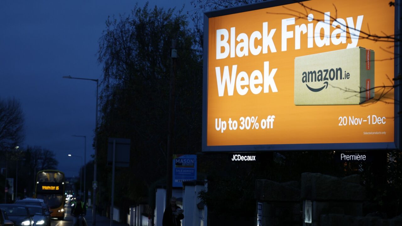 Dublin, Ireland - 26th November 2025 - A large backlit Amazon Black Friday billboard display on a dark street in Dublin city