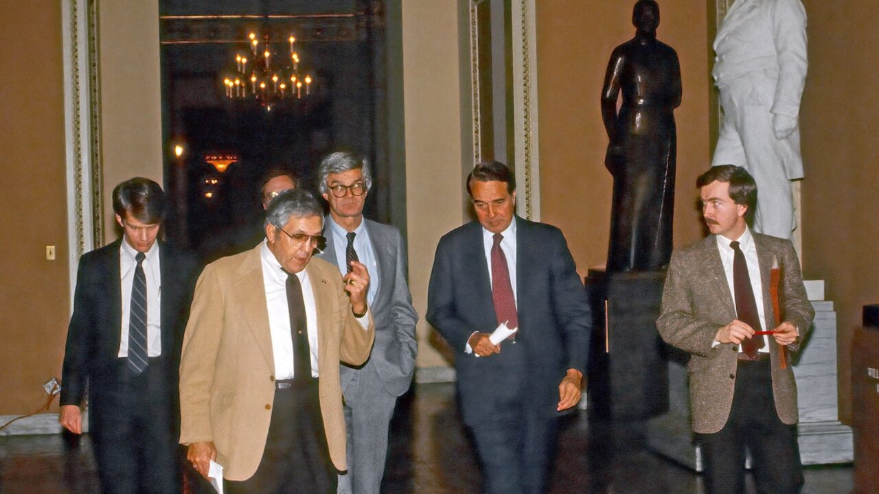 Washington DC. USA, January 9, 1985 (Center) L-R Senators Ellis Abdnor (R-SD) Rudy Boschwitz (R-MN) and Robert Dole (R-KS) walk to the Ohio clock to talk with reporters about the budget meeting