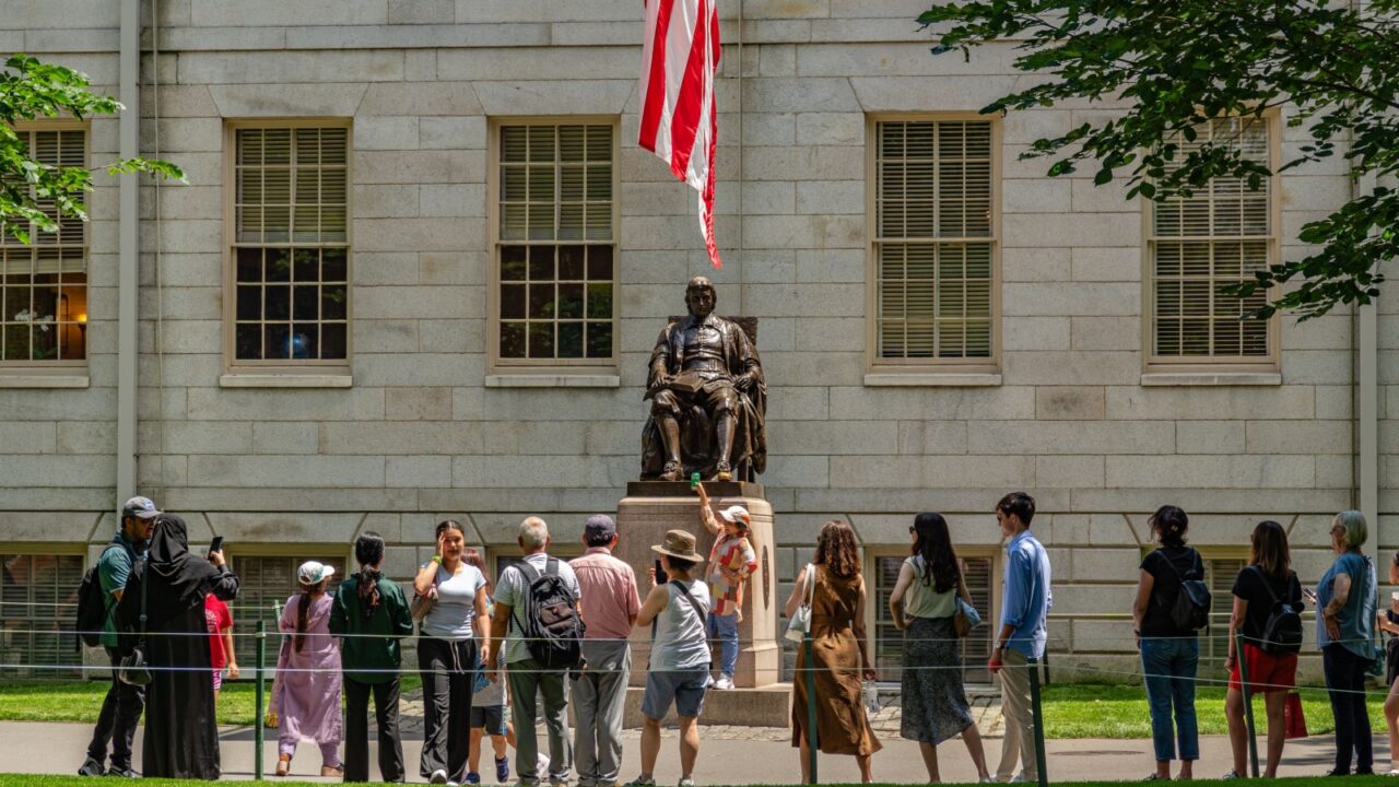 Cambridge, MA, USA - July 15, 2025: View of statue of John Harvard in university quad on the campus of this private Ivy League research university.