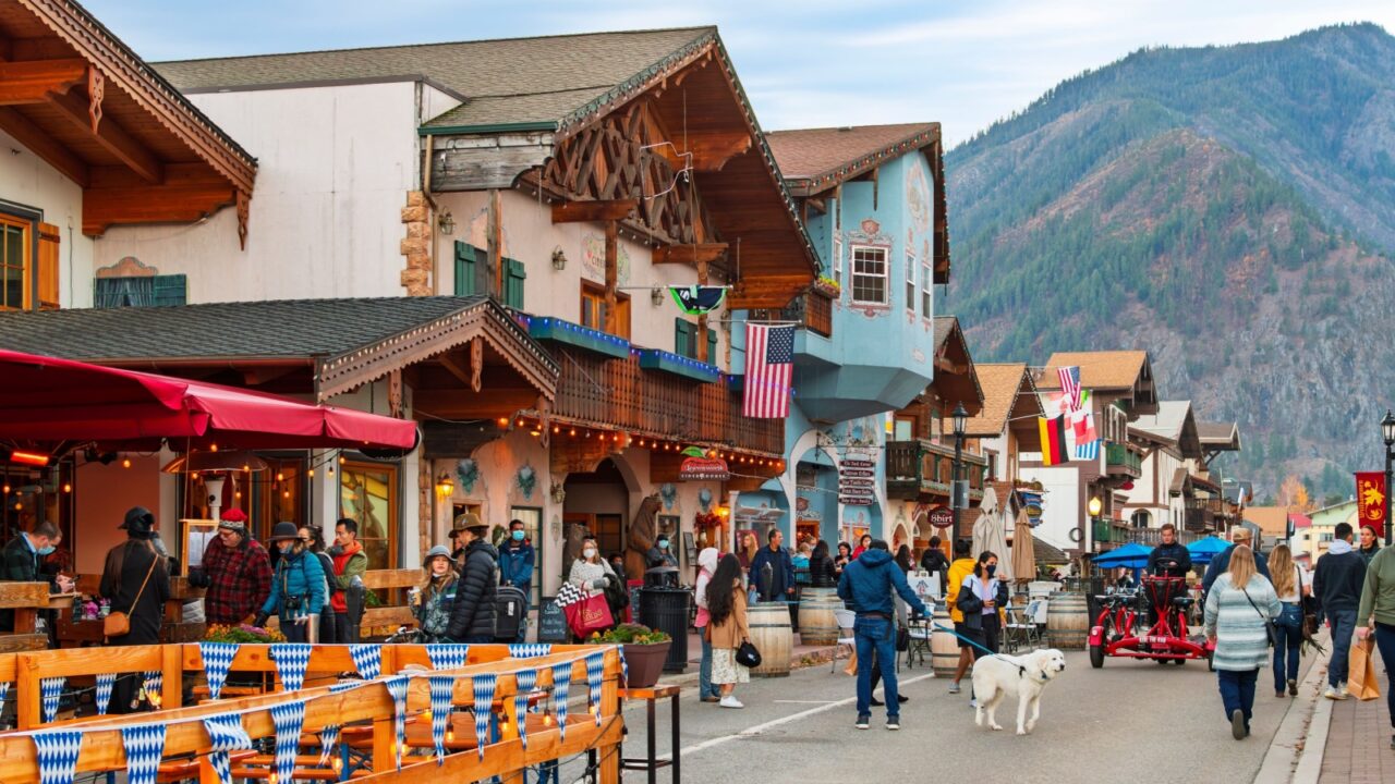 Leavenworth, Washington State - December 2 2024: Visitors enjoy the picturesque main street of shops and sidewalk cafes in the Bavarian themed small town of Leavenworth, in the Cascade Mountains.