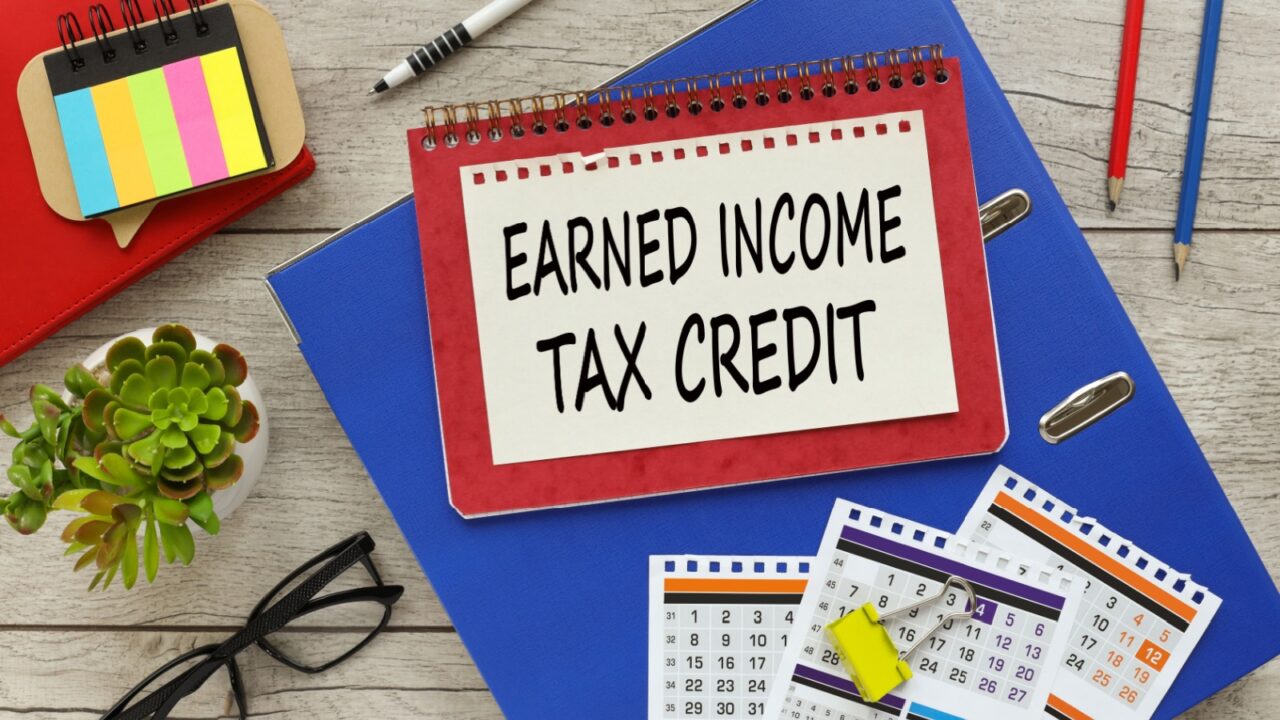 top view of the folder calendar pencils and pens. text EARNED INCOME TAX CREDIT