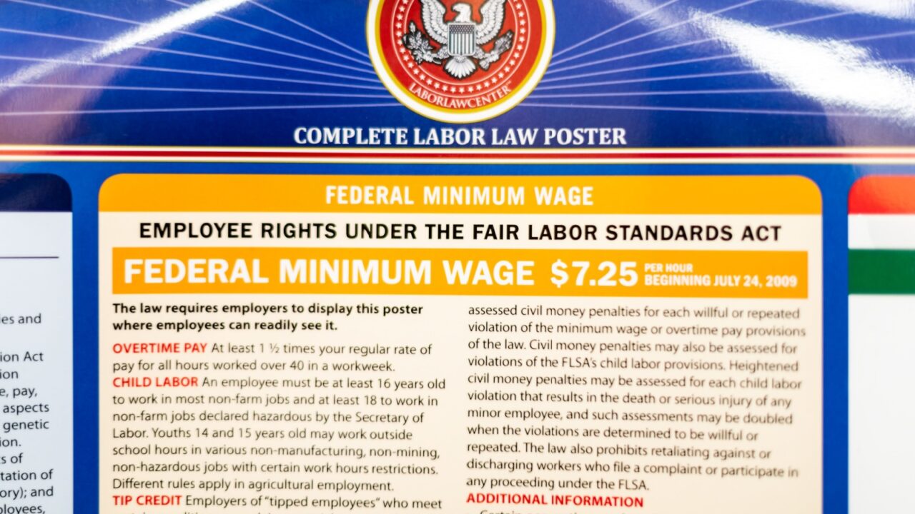 Fairfax, USA - September 29, 2018: Job Minimum Wage Labor Law regulations sign on board post poster information in Virginia office