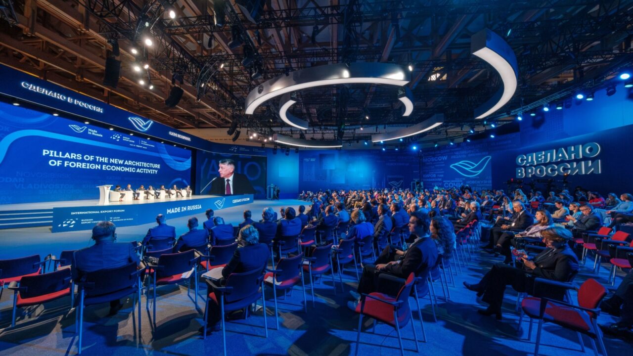 Moscow - October 19, 2023: Businesspeople attending global conference meeting in blue illuminated auditorium at Made in Russia Export Forum