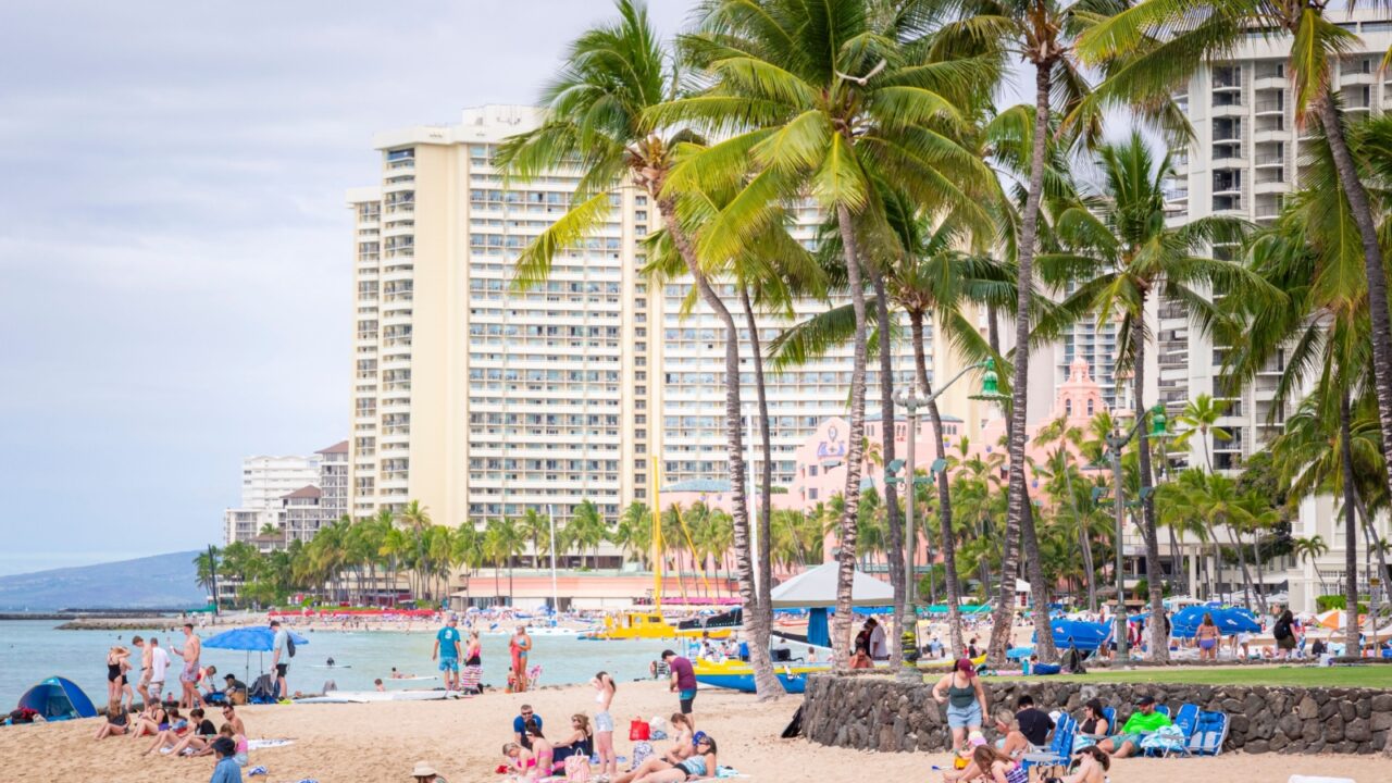 Honolulu, Hawaii, USA - February 22, 2024 - People enjoying the beach in Waikiki.