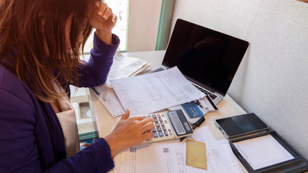 Businesswoman Financial Stress stressed by calculate expense from invoice or bill debt notification, bad financial report