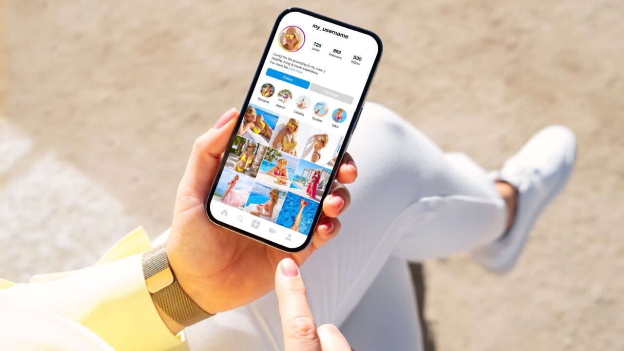 Woman holding phone in hand and viewing social media content