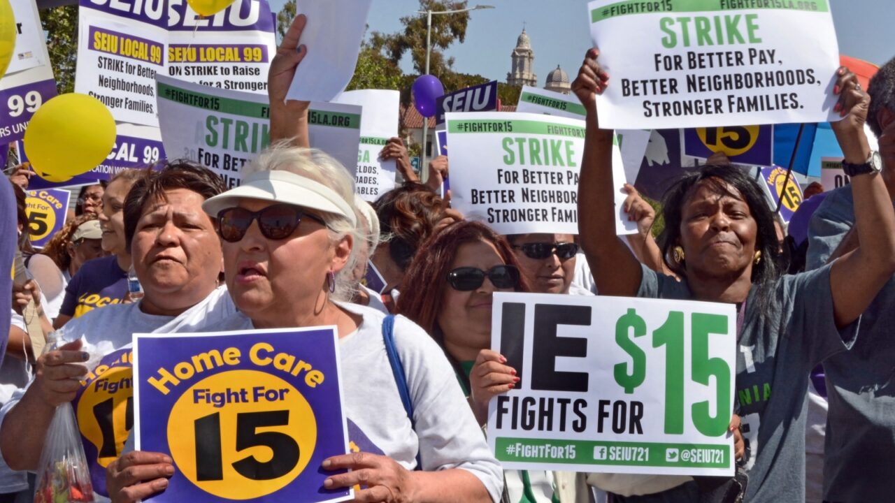 LOS ANGELES, CA APRIL 15, 2015: Protestors hold signs advocating raising the minimum wage at during a rally in Los Angeles on April 15, 2015.