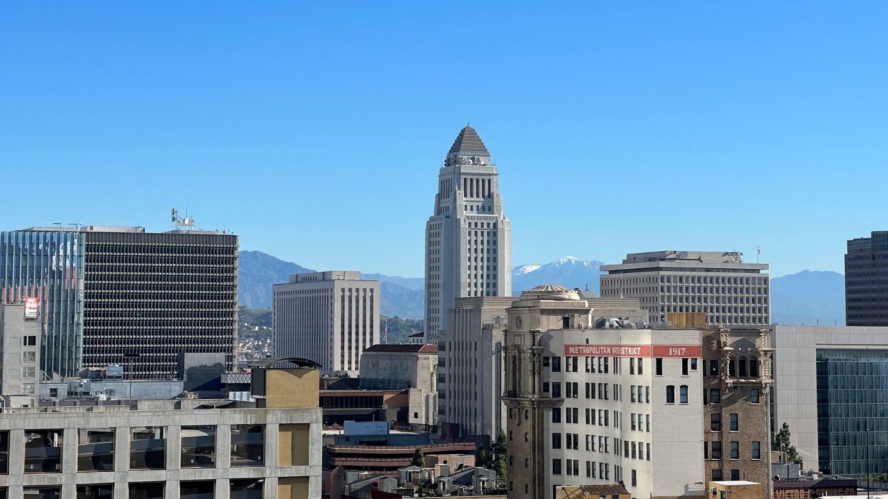LOS ANGELES, CA, JAN 2022: Downtown skyline with City Hall in center and mountains in background, seen from Bunker Hill in Financial District
