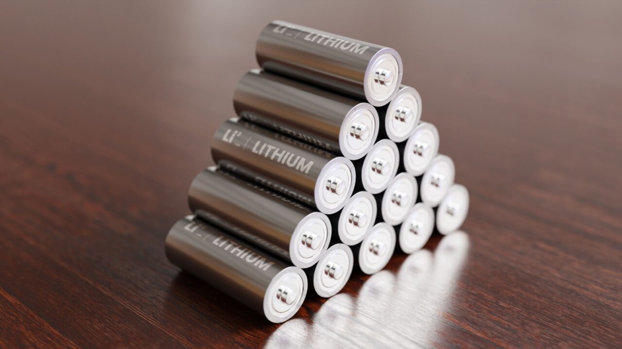 A pile of Lithium batteries on wooden table