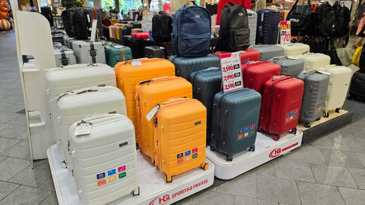 A colorful display of various luggage styles organized neatly in a retail space, showcasing travel essentials for every adventure. BANGKOK, THAILAND - November 01, 2024