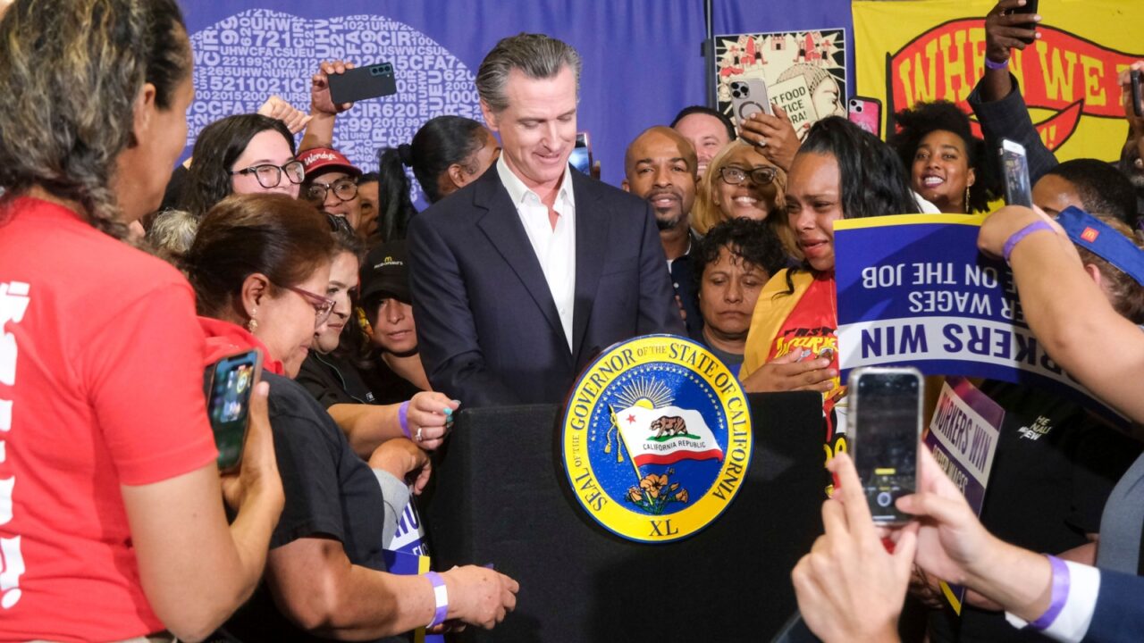 Gov. Gavin Newsom signs the fast food bill AB1228 in Los Angeles, on Thursday, Sept. 28, 2023. California’s fast food workers will have a minimum wage of $20 per hour next year under a new law.